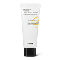 White tube of soothing overnight mask with black cap and honey-related text on plain white background