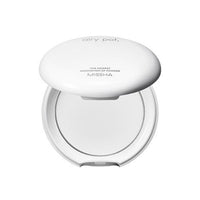 White compact powder case with translucent pressed powder and minimal branding on top against white background