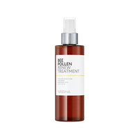 Amber spray bottle of hydrating bee pollen skin treatment with white label and silver pump dispenser on white background