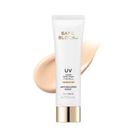 White tube of tone-up sun cream with gold cap and beige foundation swatch on white background