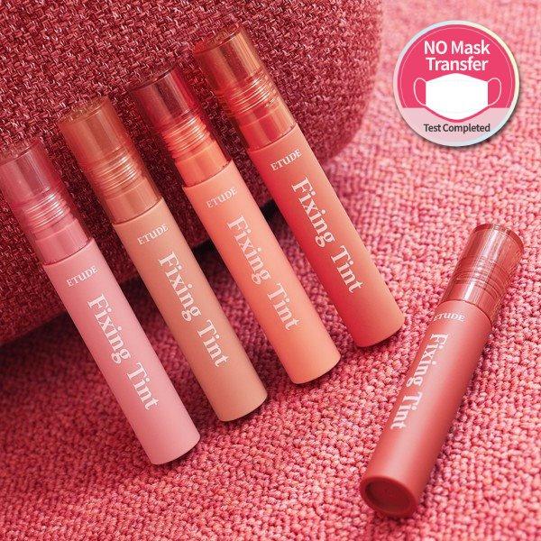ETUDE HOUSE Fixing Tint 4g #04 Ginger Milktea with long-lasting wear in warm ginger milktea shade tubes on pink fabric background