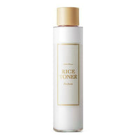 Tall white bottle of hydrating rice toner with gold cap and minimalist label design on white background