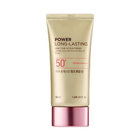 Gold tube of long-lasting pink tone-up sun cream with SPF 50+ and pink metallic cap on white background
