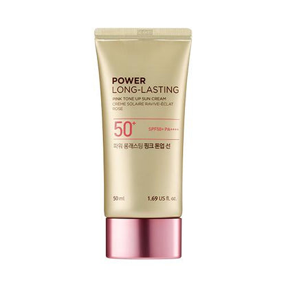 Gold tube of long-lasting pink tone-up sun cream with SPF 50+ and pink metallic cap on white background