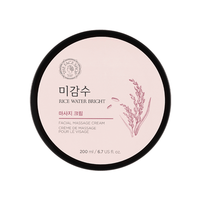 Round container of pale pink facial massage cream with rice illustration and black lid focusing on moisture boost benefits