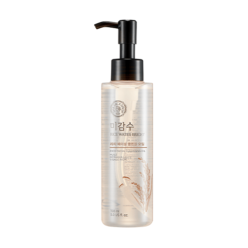 Clear pump bottle of hydrating rice water cleansing oil with delicate rice grain illustration on transparent container
