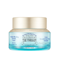 Blue glass jar of hydrating anti-aging cream with gold lid and European blending formula label