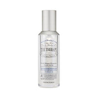Clear sleek bottle of hydrating anti-aging serum with silver cap and minimalist text design on white background