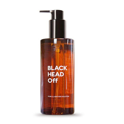 Amber pump bottle of cleansing oil labeled Blackhead Off for thorough pore clarifying on white background