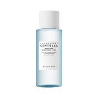 Light blue bottle of hydrating and brightening toner with white cap and minimalist label on white background
