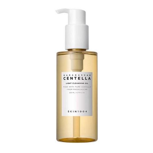 Transparent pump bottle of light cleansing oil with soft amber liquid and minimalist label on white background