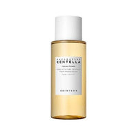 Clear amber bottle of soothing centella toning toner with white cap and minimalist label design on white background
