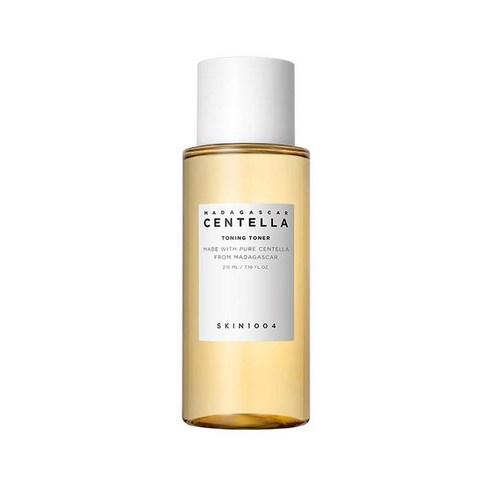 Clear amber bottle of soothing centella toning toner with white cap and minimalist label design on white background
