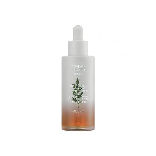 Frosted glass dropper bottle with green artemisia illustration and amber liquid for redness reduction serum