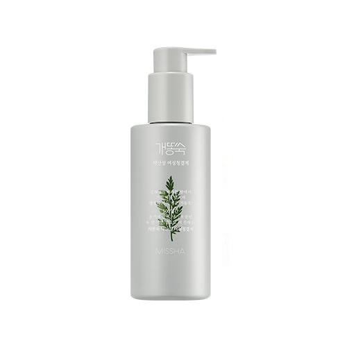 Minimalist white pump bottle of soothing feminine wash with green artemisia leaf design on front