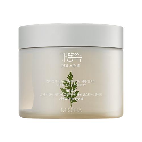 Opaque beige jar with white lid containing calming ampoule pads featuring a green artemisia leaf design on label