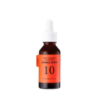 Amber glass dropper bottle with bright orange label for wrinkle care serum on white background