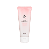Pink and white gradient tube of gentle exfoliating apricot blossom peeling gel with black and red text on white cap