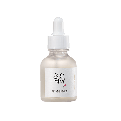 Frosted glass dropper bottle of brightening serum with white label featuring Korean text on white background