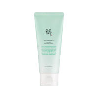 Light green tube of Green Plum Refreshing Cleanser featuring gentle exfoliation for smooth, hydrated skin on white background
