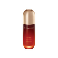Tall gradient amber to gold bottle with smooth curves containing anti-aging essence product