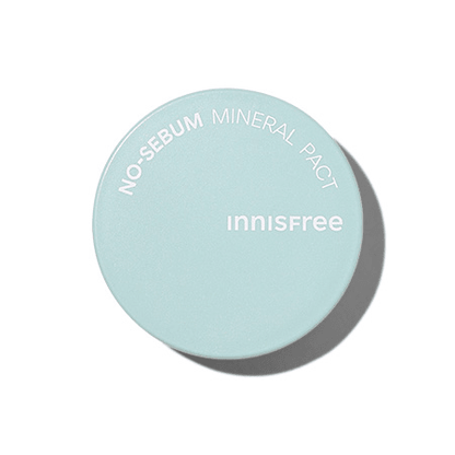 Light blue compact powder case with white text highlighting oil control benefits on a clean white background