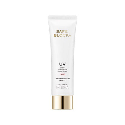 White squeeze tube with gold cap of brightening SPF50+ anti-pollution sun protection cream on white background