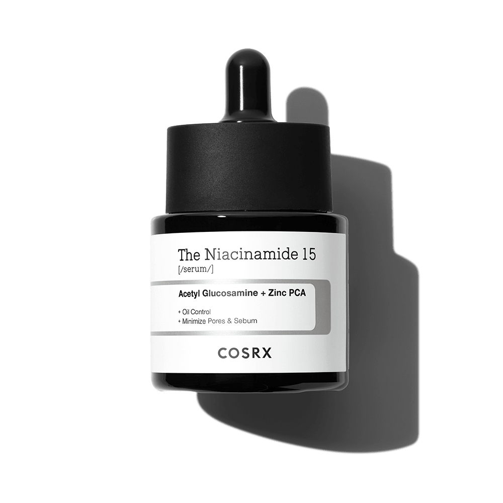Dark glass dropper bottle of niacinamide serum with label highlighting oil control and pore minimizing benefits