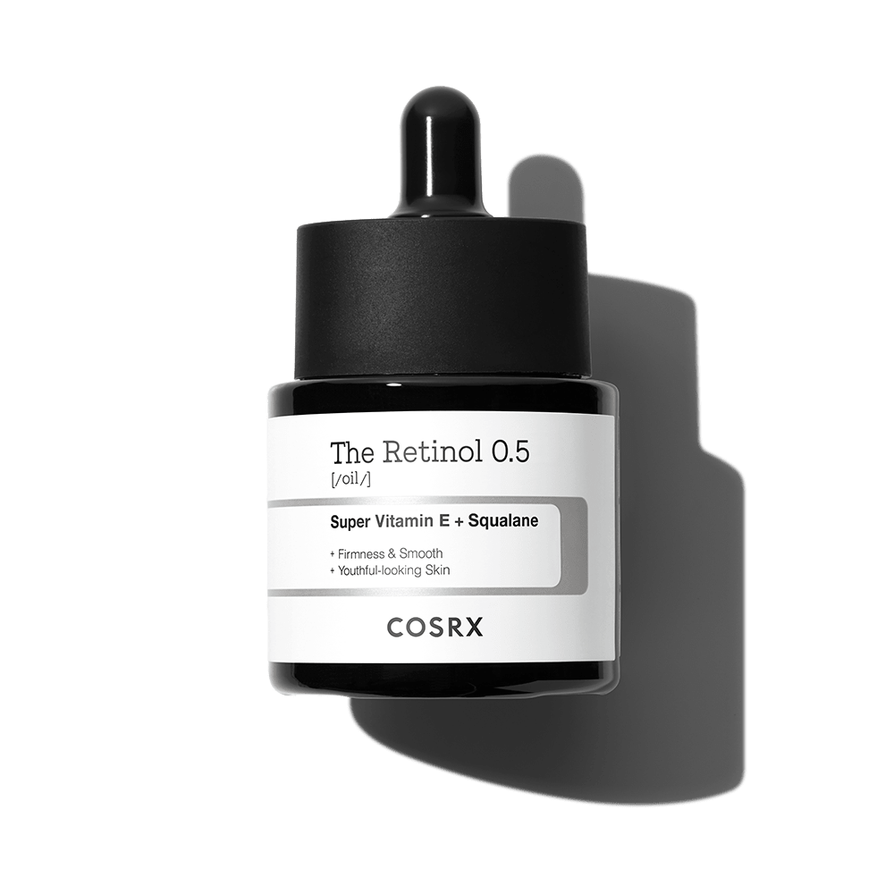 Dark glass dropper bottle of retinol and squalane oil serum promoting firmness and youthful smooth skin appearance