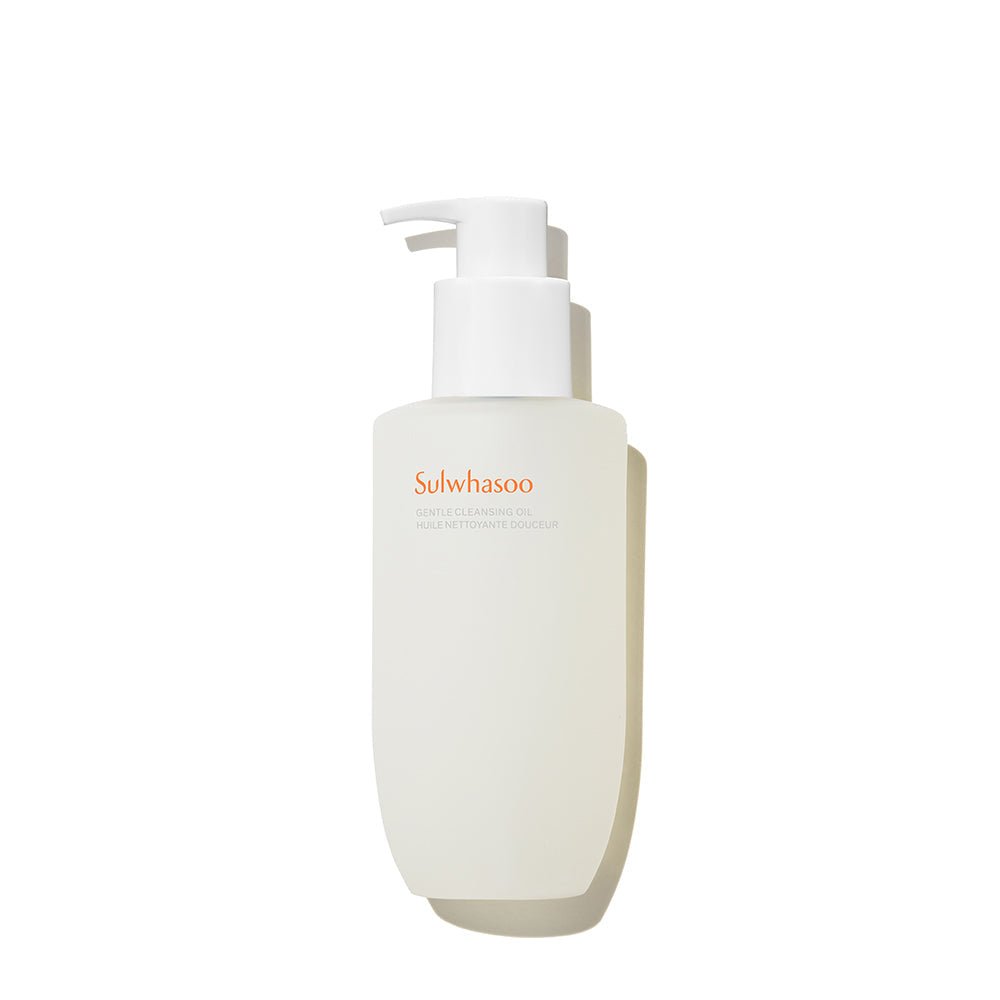 Minimalist white pump bottle of gentle cleansing oil with subtle orange branding on a clean white background