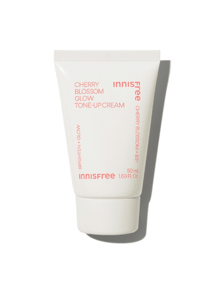 Small white tube of brightening tone-up cream with soft pink text highlighting cherry blossom and glow benefits