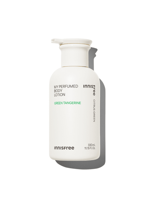 White pump bottle of perfumed body lotion with green text highlighting citrus green tangerine scent and hydration boost