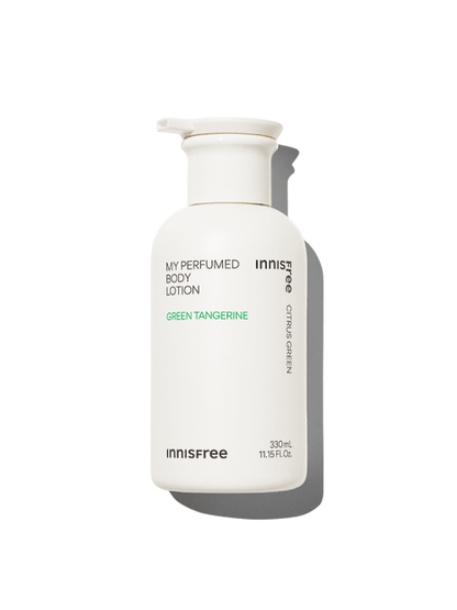 White pump bottle of perfumed body lotion with green text highlighting citrus green tangerine scent and hydration boost