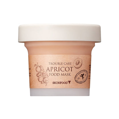 Small light peach jar of soothing apricot face mask with simple natural label and white lid on white background