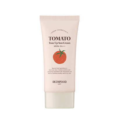 Tube of light beige sun cream with tomato illustration, highlighting SPF50+ UV protection formula for skin tone brightening