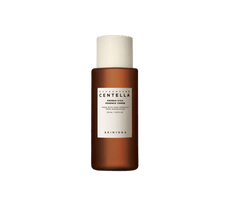 Brown bottle of calming essence toner with white cap and minimalist label on a white background
