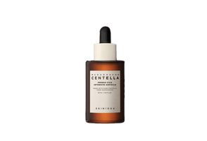 Amber glass dropper bottle of hydration ampoule serum with white label and black dropper cap on white background