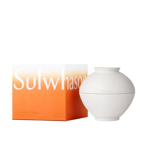 Matte white rounded cream jar next to an orange and white box with bold brand lettering for youthful skin appearance