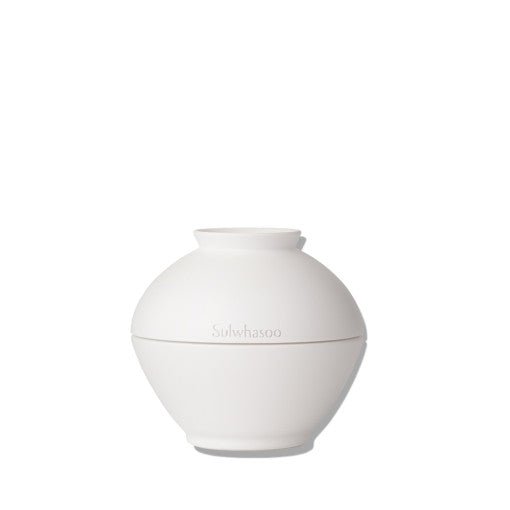 Minimalist white spherical jar of eye cream with smooth matte finish and subtle brand embossing on plain background