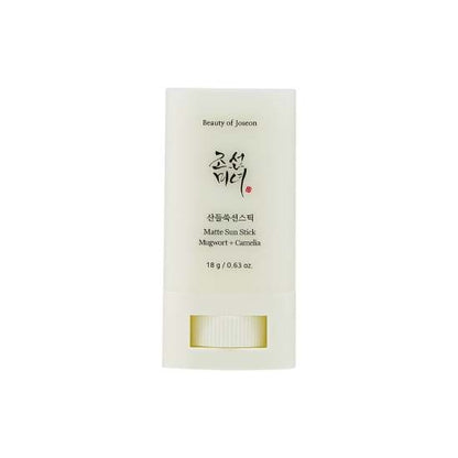 Minimalist white sun stick container with black text for matte mugwort and camelia formula, 18g size
