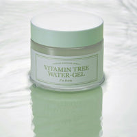 Frosted jar of light green hydrating water-gel with white lid reflecting on smooth watery surface