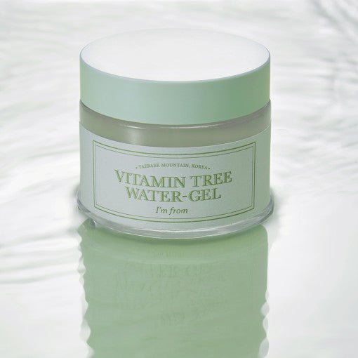 Frosted jar of light green hydrating water-gel with white lid reflecting on smooth watery surface