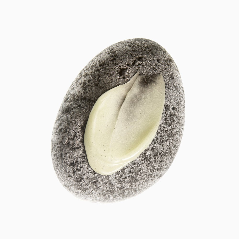 beplain Mung Bean Pore Grinding Cleansing Balm 100ml swatched cream texture on smooth gray stone background