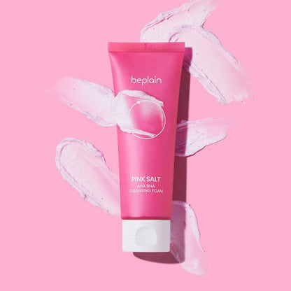 beplain Pink Salt AHA BHA Cleansing Foam 120ml in pink tube with creamy textured foam swipes emphasizing exfoliation benefits