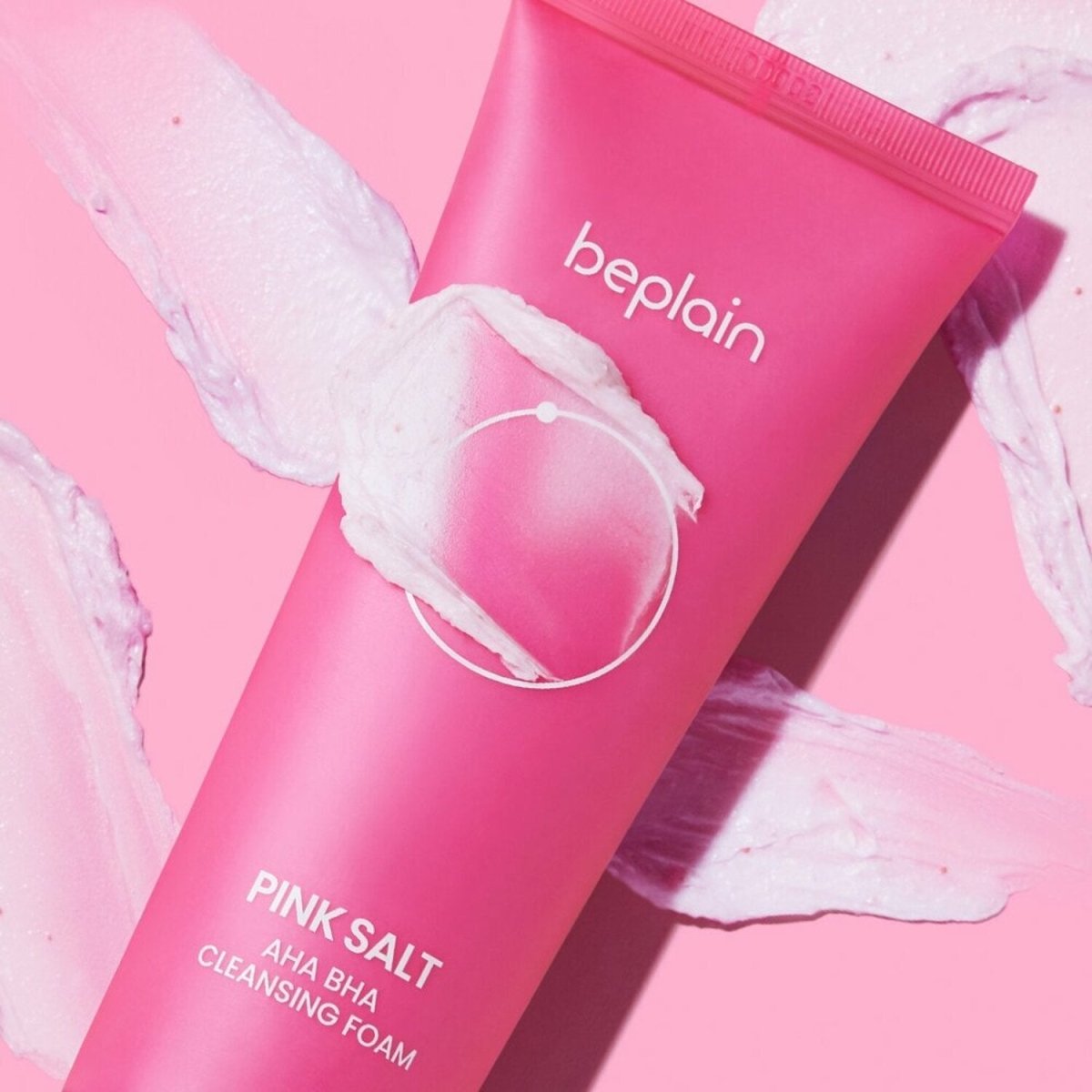 beplain Pink Salt AHA BHA Cleansing Foam 120ml in pink tube with exfoliating foam texture on soft pink background