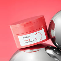beplain Vita C Cleansing Balm 100ml in coral jar with white label on reflective silver sphere background