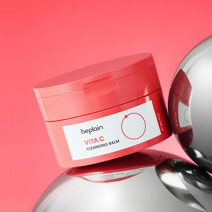 beplain Vita C Cleansing Balm 100ml in coral jar with white label on reflective silver sphere background