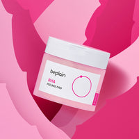 beplain BHA Peeling Pad 50P container with white lid on pink and red abstract background for gentle exfoliation