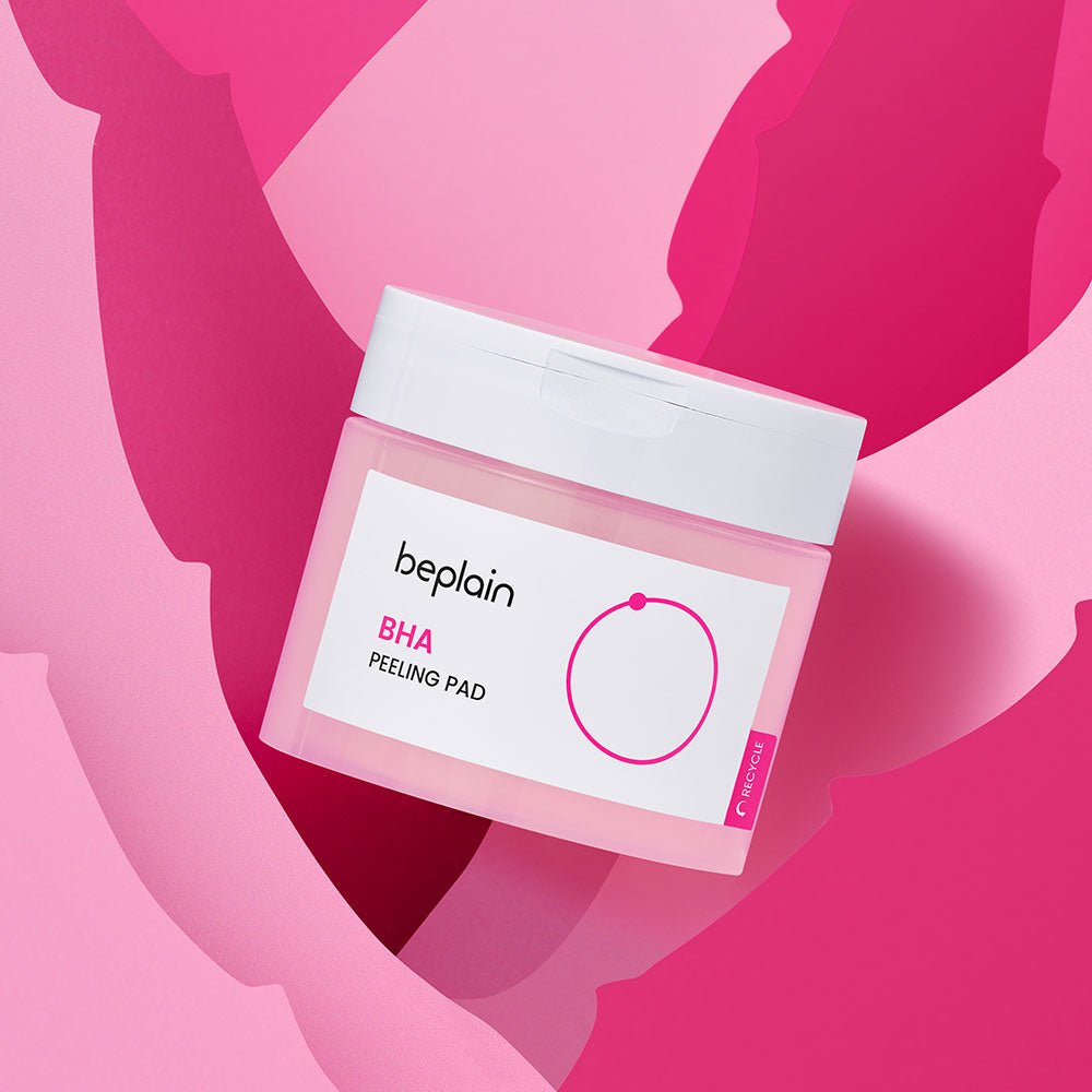 beplain BHA Peeling Pad 50P container with white lid on pink and red abstract background for gentle exfoliation