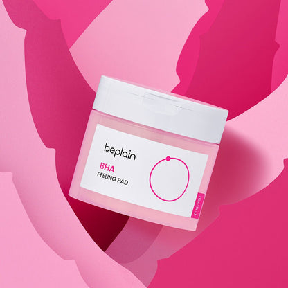 beplain BHA Peeling Pad 50P container with white lid on pink and red abstract background for gentle exfoliation